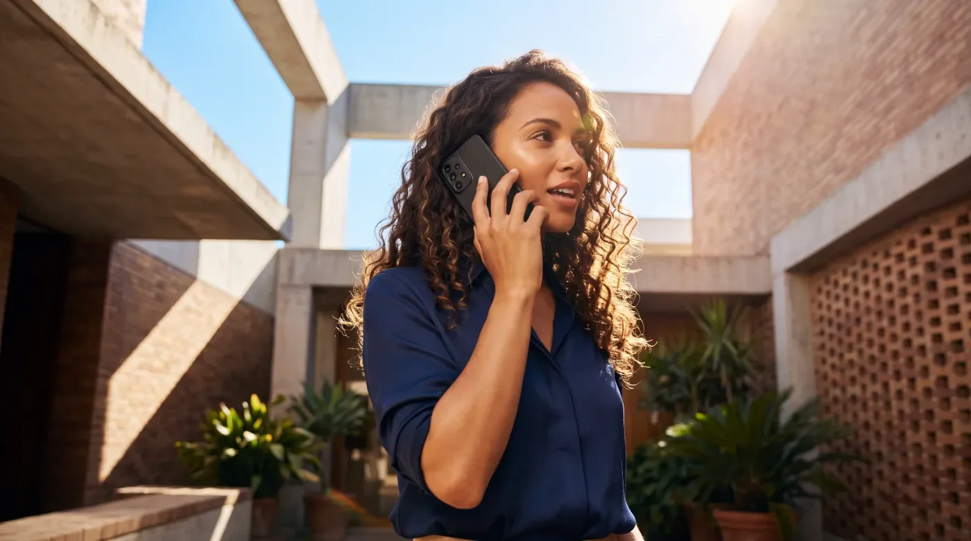 Woman talking on the phone outdoors, illustrative image